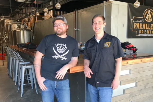 Parallel 45 Brewing co-owners in front of bar