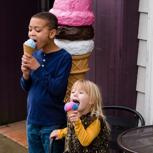 Two kids enjoying a scoop of ice cream from Independent Ice Cream