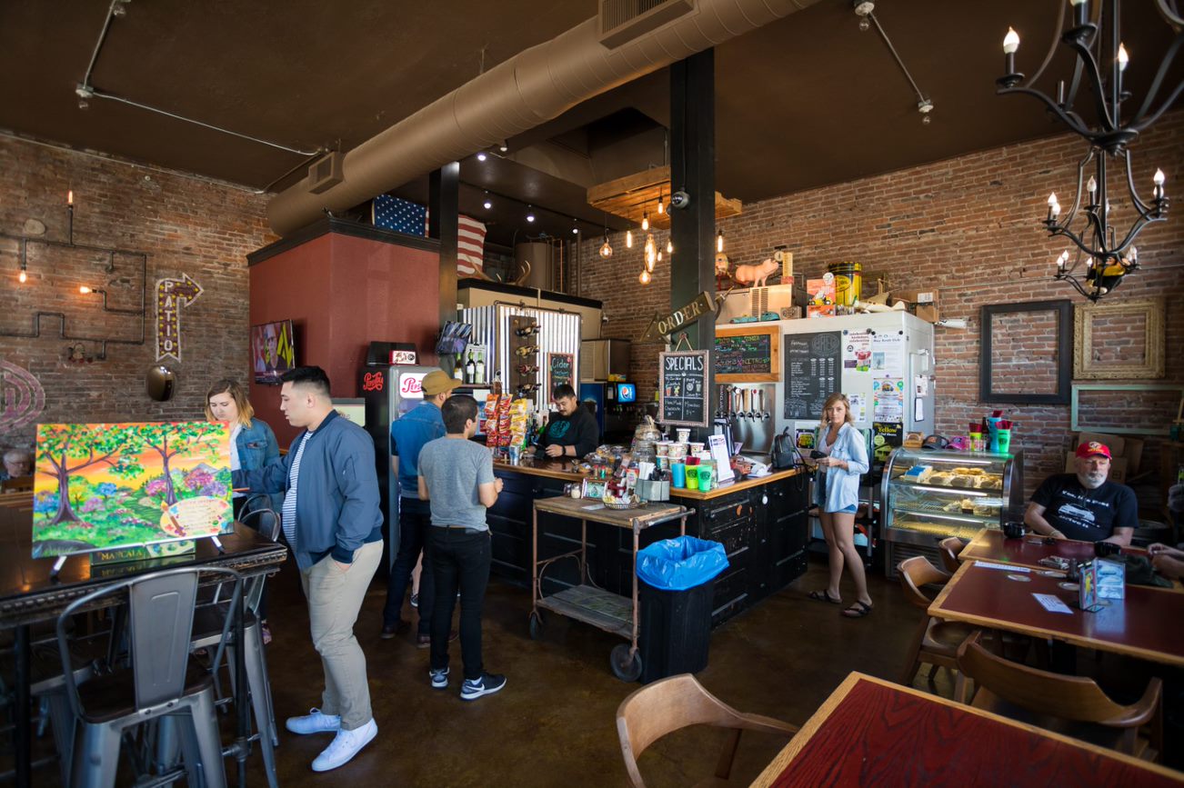 An interior shot of BREW with counter, tables and people